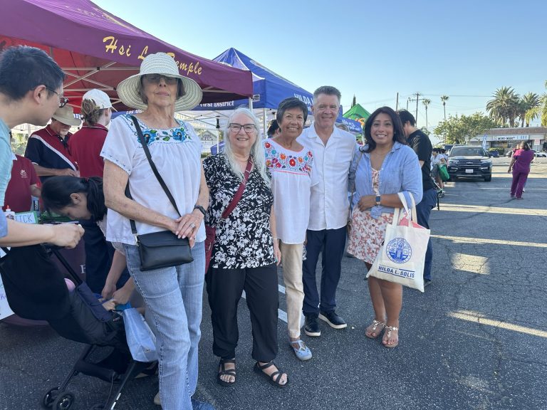 Christine Salazar with community members at a neighborhood fair